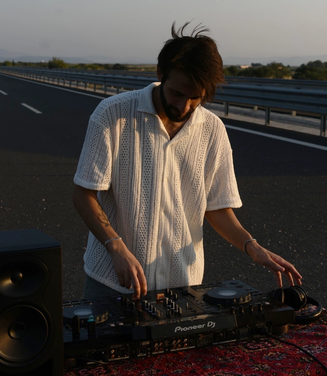 KAIRO performing a live DJ set under dramatic stage lighting
